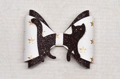 a black and white bow with gold stars on it