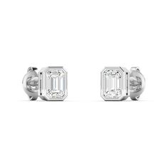 Our new emerald cut bezel set oval diamond studs are hand fabricated for everyday and evening wear. These also come in ruby, blue sapphire, pink sapphire with halo diamonds. 14K & 18K yellow, gold, or white gold Total Emerald Cut Diamond Weight: .5 cts, 1 cts, 2 cts Grams Gold: .84 gms, 1.61 gms Bezel set emerald cut diamond studs D-E-F colore, VVS/VS clarity﻿ Made in Los Angeles and New York Complimentary gift wrapping provided Bezel Set Earrings, Signature Bracelet, Diamond Stacks, Bridal Diamond Jewellery, Linking Rings, Emerald Cut Diamond, Bezel Set Diamond, Diamond Education, Bridal Bands