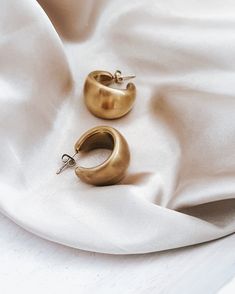 Our Enoch Matte Gold Earrings are the perfect touch of luxe to transform any look. Exquisitely crafted in a matte gold tone, these statement earrings add a sophisticated and unique element to any ensemble. Crafted with waterproof material, these earrings are perfect for any occasion - rain or shine! Brushed, Matte Gold finish 2 sizes to choose from Waterproof Tarnish resistant 18K Gold plated stainless steel Hypoallergenic Chic Gold Brass Earrings, Chic Brass Hoop Earrings For Formal Occasions, Modern Gold Jewelry With Matte Finish, Modern Matte Finish Gold Jewelry, Matte Gold Brass Hoop Earrings, Chic Brass Hoop Earrings For Pierced Ears, Matte Gold Brass Hoop Earrings For Pierced Ears, Chic Gold-tone Brass Hoop Earrings, Modern Matte Gold Brass Hoop Earrings