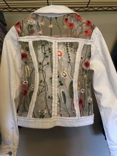 a white jacket with flowers on it