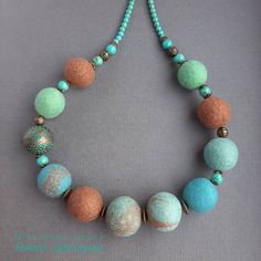 a necklace with several different colored beads on it