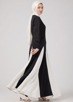 Elevate your modest fashion collection with the Monochrome Grace Maxi Dress, meticulously crafted from durable crepe polyester. This stunning piece features a sophisticated black and white color block design that exudes elegance and modernity. The flowing panels create a graceful silhouette, perfect for any occasion where modesty meets style. The dress includes long sleeves and a high neckline, providing both comfort and coverage. Make a statement with this timeless and versatile addition to you White Elegance, Abaya Dress, Black And White Colour, High Neckline, British Indian, Black Maxi Dress, Fashion Lover, Modest Fashion, Fashion Collection