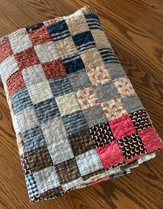 a piece of quilt sitting on top of a wooden floor