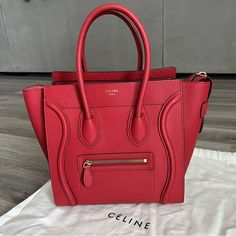 Very Good Condition. Rarely Used. Authentic. Light Markings At Exterior Leather Which Is Shown In The Photos. From Pet Free And Smoke Free Home. No Odor. From The 2017 Phoebe Philo Collection. Red Baby Grained Calfskin Leather Cline Micro Luggage Tote With Gold-Tone Hardware, Dual Rolled Top Handles, Foil- Stamped Logo Accent At Front, Single Exterior Zip Pocket, Tonal Suede Lining, Three Interior Pockets; One With Zip Closure And Zip Closure At Top. Includes Dust Bag. Handle Drop: 5" Height: 11" Width: 15" Depth: 6" Celine Micro Luggage, Celine Micro, Phoebe Philo, Red Baby, Celine Bags, Bag Handle, Calf Skin, Zip Pockets, Satchel