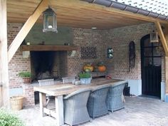 an outdoor dining area with table and chairs