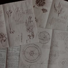 several drawings are shown on top of some paper