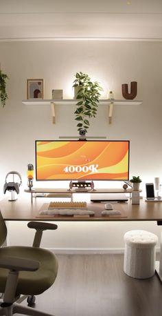 an office desk with a computer monitor and chair in front of it, surrounded by potted plants