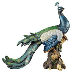 a statue of a peacock sitting on top of a tree stump