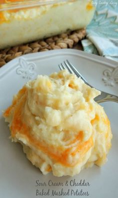 a white plate topped with mashed potatoes next to a fork