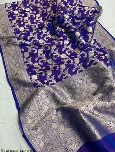 a blue and white sari with floral designs on the palan silk material,