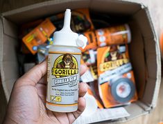 a hand holding a bottle of gorilla glue