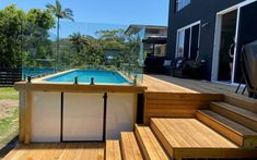 an above ground pool surrounded by wooden steps