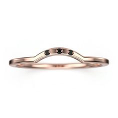 a rose gold wedding band with black diamonds