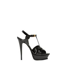 Saint Laurent patent leather Tribute sandal; golden hardware. 4.5"/105mm stiletto heel Open toe. Wide straps loop together over the vamp. T-strap connects to adjustable buckled ankle strap; engraved logo. Halter strap overlaps ankle strap at side. Leather lining and sole. "Tribute" is made in Italy. Luxury T-strap Sandals For Formal Occasions, Designer T-strap Sandals For Evening, Designer T-strap Heels For Party, Modern T-strap Heels For Evening, Luxury Formal T-strap Sandals, Luxury T-strap Heels For Party, Luxury T-strap Sandals With Ankle Strap For Party, Luxury T-strap Sandals With Open Heel For Party, Luxury T-strap Heels With Heel Strap