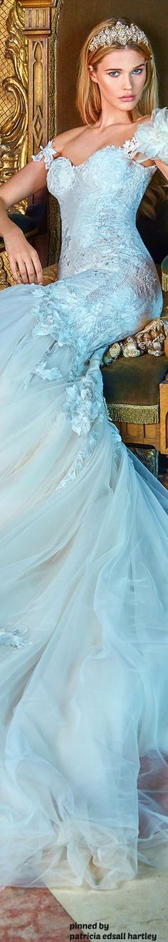 a woman in a wedding dress sitting on a chair