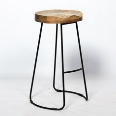 a wooden stool sitting on top of a metal frame