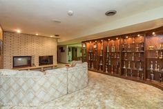 a living room filled with lots of furniture and a flat screen tv mounted to the wall