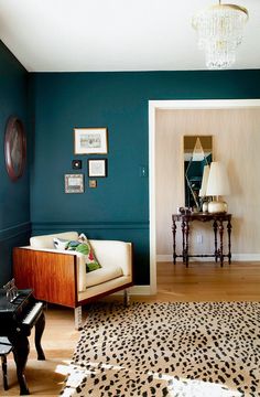 a living room with blue walls and leopard print rug