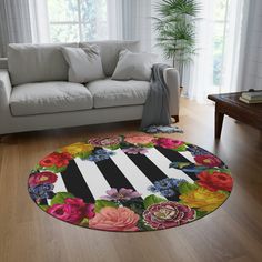 a living room with a white couch and flower rug