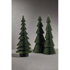 three green ceramic christmas trees sitting next to each other