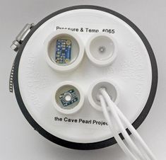 an electronic device with wires attached to the top and bottom parts on it's side