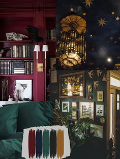 a living room filled with lots of furniture next to a book shelf covered in books