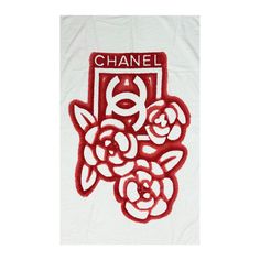 a white towel with red flowers and the word chanel on it's side