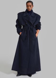 Color: Navy Midweight wool blend fabric Oversized silhouette Peak lapels Exaggerated padded shoulders Button epaulets Welt hip pockets  Button cuffs Detachable belt strap Back vent hem Double breasted front button closure Unlined 95% Wool 5% Cashmere Dry Clean  By The Frankie Shop. Imported Navy Trench Coat, Oversized Wool Coat, Oversized Trench Coat, Long Pencil Skirt, Trench Coat Outfit, 2023 Color, Fitted Coat, The Frankie Shop, Pleated Long Skirt