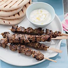 skewers of meat and pita bread on a plate