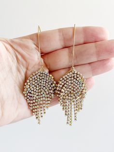 Gold Statement Earrings ⟡ all items are designed and handcrafted in our studio ⟡ Yellow gold and crystal fringe earrings. Stun at every event with these threader earrings. The cascading crystal fringe creates a statement for all of your most glamorous moments. Let these sparkling accessories be the conversation starter at your next event. OVERVIEW-gold plated over stainless ear wire-glass crystalsLooking for more statement earrings? Click here! OTHER INFORMATION-All pieces come in a beautiful gi Sparkling Accessories, Gold Threader Earrings, Crystal Fringe, Wired Glass, Threader Earrings Gold, Aurora Borealis Crystal, Gold Statement Earrings, Threader Earrings, Tassel Fringe