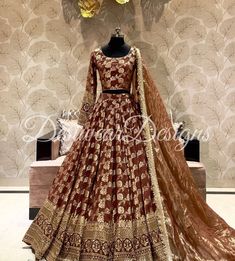 a red and gold lehenga is displayed in front of a floral wallpaper