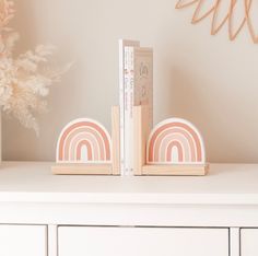 two bookends on top of a white dresser