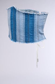 The AKIRA Label Denim Babe Under Bust Belt in Blue Multi is a corset-inspired accessory crafted from a super stretchy, two-tone denim fabrication. This waist-cinching piece features a gently-frayed hemline and an adjustable lace-up back closure. Style it with a white tee and cowgirl boots for a cutesy Western vibe.  - 71% Cotton, 28% Polyester, 1% Spandex - Super Stretchy - Imported  (all measurements are approximate from a size 1X) - 31.5” Length - 9.5” Widest Width Product ID: 394867 White Tee, Cinched Waist, Cowgirl Boots, Two Tone, Lace Up, Spandex, Boots, Lace, Fabric