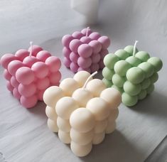 four candles are arranged in the shape of grapes