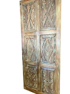 an old wooden door with intricate carvings on it