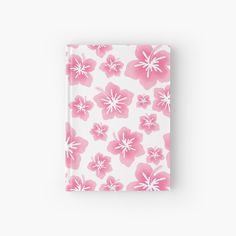 a pink and white flower pattern on a small notebook hardcover journal with clippings