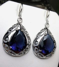 Simulated Blue Sapphire Earrings  Big Teardrop Design#E28 Custom Made This is a brand new Art Nouveau/Victorian inspired filigree sterling silver pair of teardrop simulated blue sapphire earrings. The gorgeous 12ctw man-made blue gemstones are 16mm (5/8") by 12mm (1/2") in size each. The earrings are marked 925 for sterling silver and are 1-11/16" long by 13/16" wide. Notice the beautiful swirl like craftsmanship of the silver filigree settings. This is a well made beautiful pair of silver earri Blue Gemstone Teardrop Earrings For Formal Events, Classic Blue Teardrop Earrings, Blue Elegant Teardrop Pendant Earrings, Blue Elegant Teardrop Earrings, Elegant Blue Teardrop Earrings, Blue Pear-shaped Teardrop Earrings, Elegant Blue Teardrop Pendant Earrings, Blue Pear-shaped Teardrop Earrings For Formal Occasions, Blue Teardrop Earrings For Formal Occasions