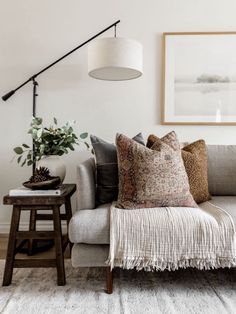 a living room filled with furniture and a lamp