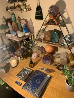 a wooden table topped with shelves filled with rocks and other items on top of it