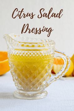 an image of citrus salad dressing in a glass pitcher