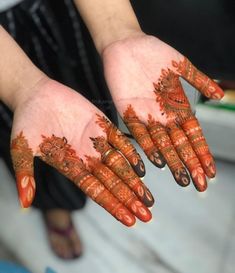 two hands with henna designs on them