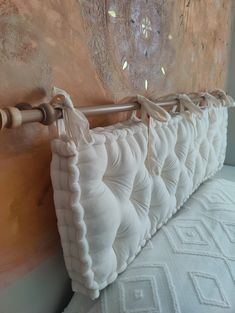 a close up of a white pillow on a bed