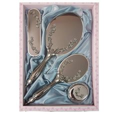 three spoons in a pink box with blue satin