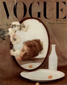 a magazine cover with an image of a woman's face and flowers in the mirror