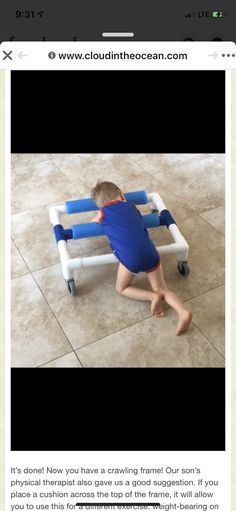 a little boy playing with a toy on the floor