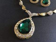 "** This necklace comes with a matching bracelet together with a pair of earrings (studs at back design). ** Featuring lovely teardrop shaped pendants embellished with clear rhinestones crystals and green glass stones on top. Great to wear on your wedding day or party event!! Color: gold plated with clear rhinestone crystals and green glass stones Size: necklace measures around 19\" long x center 2\" drop x 1\" width, bracelet 8.5\" long x 0.75\" width and earrings 1.35\" long x 0.75\" width ** Emerald Teardrop Pendant Necklace For Weddings, Emerald Pear-shaped Necklace For Wedding, Emerald Pear-shaped Wedding Necklaces, Elegant Emerald Teardrop Pendant Necklace For Weddings, Pear-shaped Emerald Necklace For Wedding, Green Pear-shaped Emerald Necklace For Wedding, Emerald Drop Jewelry For Weddings, Emerald Drop Wedding Jewelry, Elegant Green Teardrop Bridal Necklace