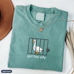 This silly goose shirt: "Got Too Silly", makes a totally unique goose gift for any goose lover, meme fanatic, or funny t-shirt collector. Grab this Comfort Colors® tee today while it's on sale! Delivery Times: ◦ Production: 1 business day (avg.)  ◦ Shipping: 3 business days (avg.) Overview: ◦ Comfort Colors® branded retro t-shirt with muted vintage-style colors & a relaxed fit ◦ Pre-shrunk, ethically-sourced, 100% ring-spun American cotton ◦ Relaxed fit with the option to size up for an"oversize Funny Shirts Cricut, Cute Funny Shirts, Silly Goose Shirt, Funny T Shirts For Women, Funny Graphic Tees For Women, Fun Tshirt Designs, Cricut Tee Shirt Ideas, Cricut Shirt Ideas Women, Cute Womens Clothes