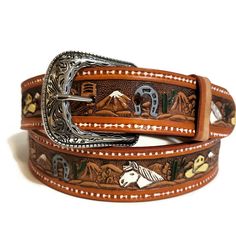 Treat yourself to a gift you truly deserve! Adorn yourself with the Western Horseshoe Leather Belt for Him and showcase your sophisticated taste in fashion and accessories, all while exuding that timeless rodeo charm. *MADE FROM EXCELLENT QUALITY LEATHER, it comes with pristine genuine leather that is hand-crafted and tested through time. *WITH AN EMBOSSED  HORSE AND HATS DESIGN, it shows your true love for the western style giving you that laidback cowboy look. *INCLUDES AN EASY SNAP BACK STRAP Adjustable Brown Belts With Silver Buckle, Brown Adjustable Belt With Silver Buckle, Adjustable Brown Belt With Silver Buckle, Western Style Brown Belt For Gift, Western Style Brown Belt As Gift, Brown Western Style Belt For Gift, Adjustable Hand Tooled Belt Perfect For Gifts, Adjustable Hand Tooled Belt As Gift, Hand Tooled Brown Belt For Gift