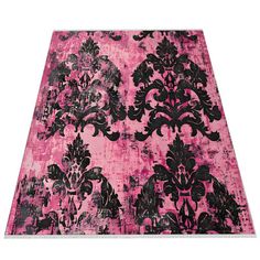 a pink rug with black and white designs on the bottom, in front of a white background