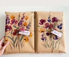 two wrapped packages with flowers painted on them